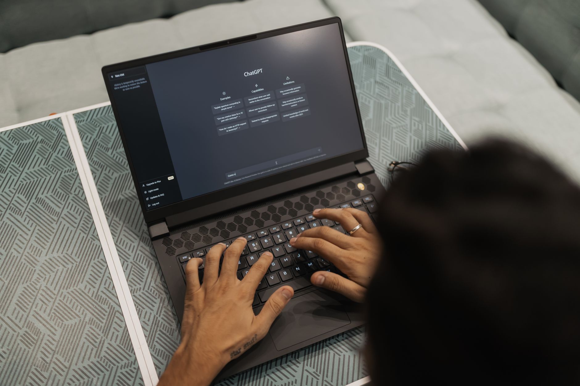 Person typing on a laptop with a ChatGPT style chat window open