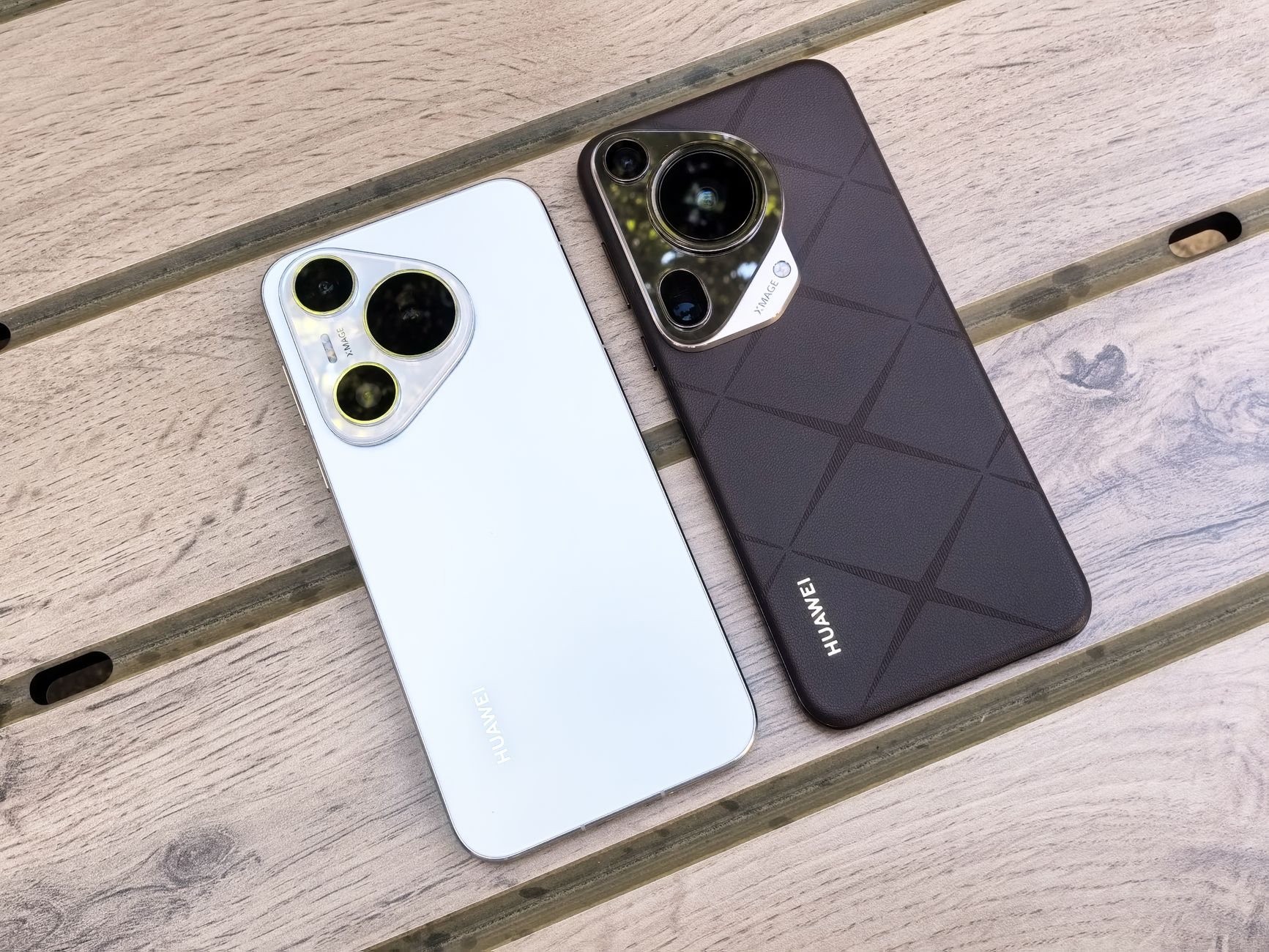 Two smartphones sit side by side on a desk, each showing a different AI chat assistant interface.