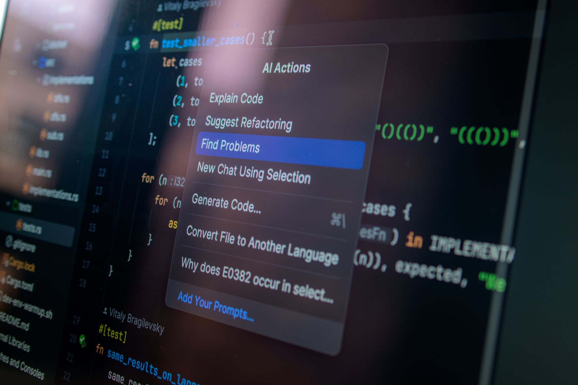 Developer typing code in an editor with AI suggestions on a laptop