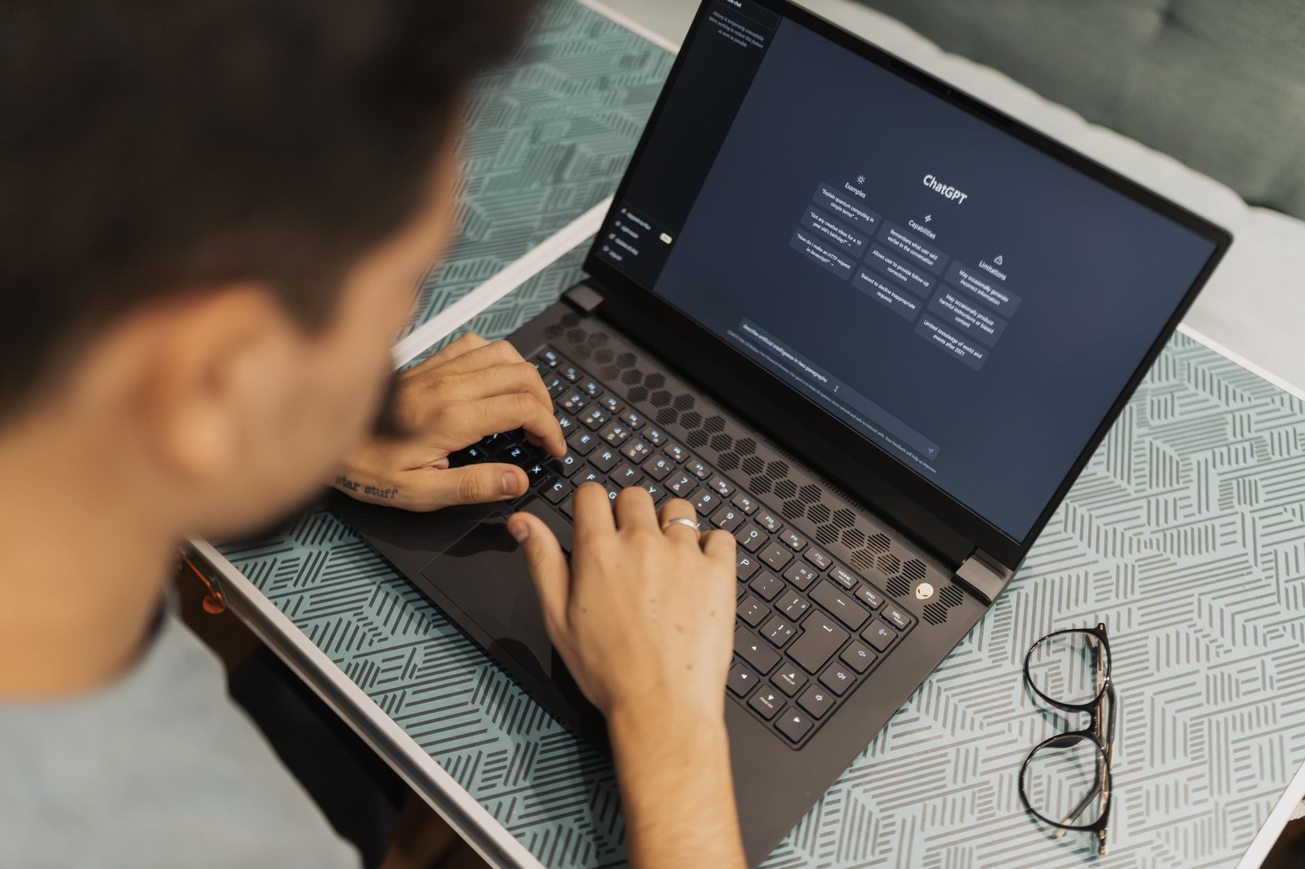 A person configuring an AI assistant on a laptop in a bright office.