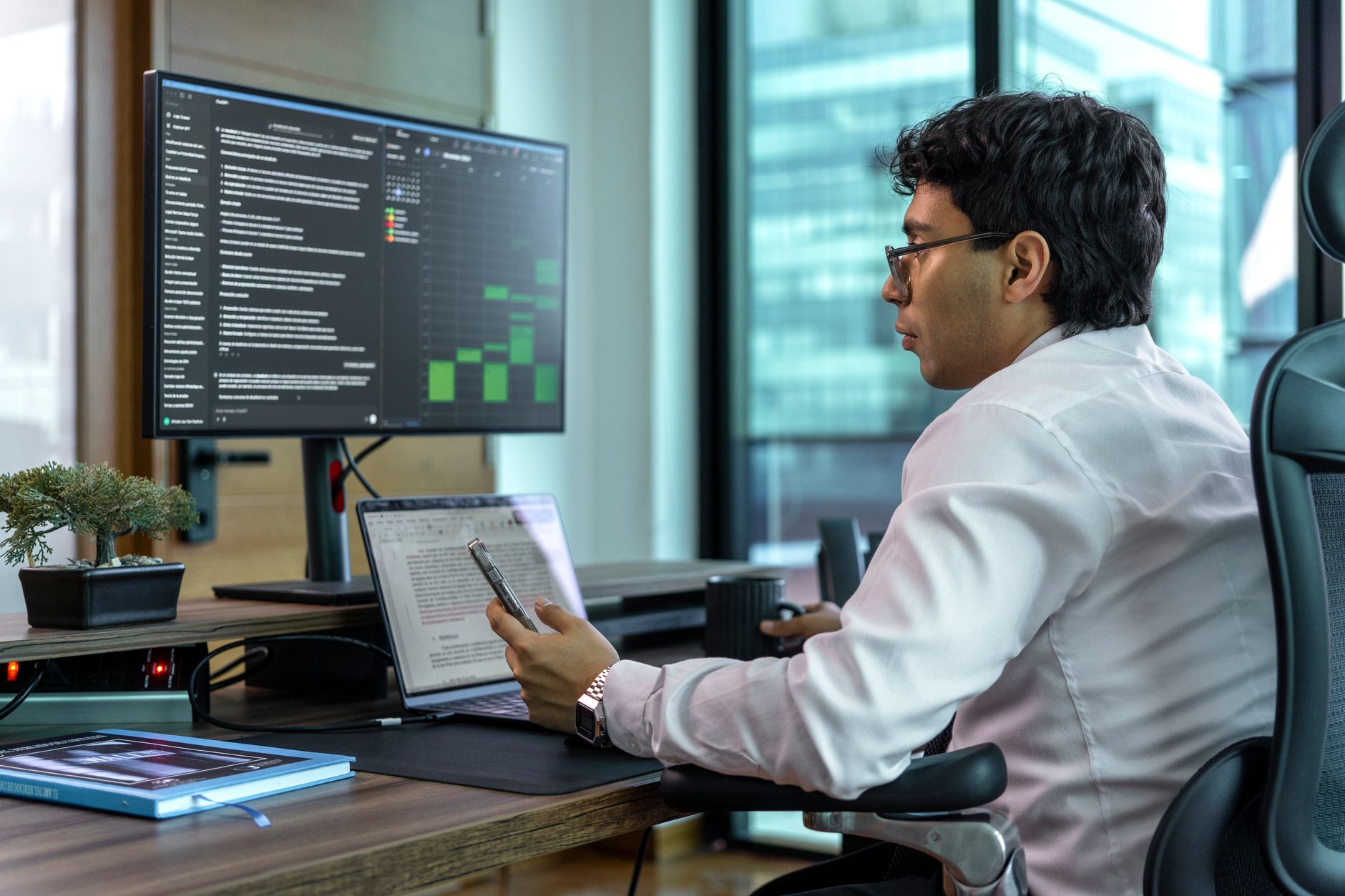 A person reading a long document on a computer screen while taking notes.